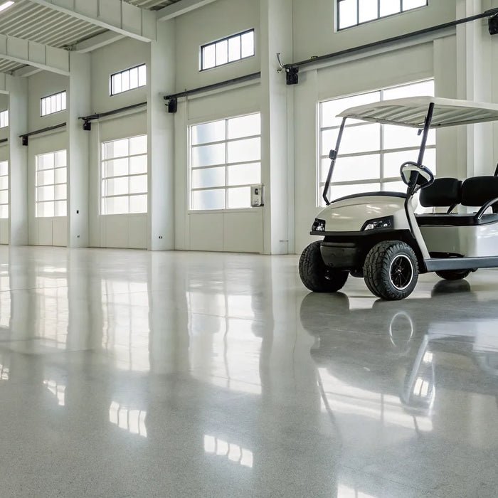 A golf cart in a garage being inspected for common problems.