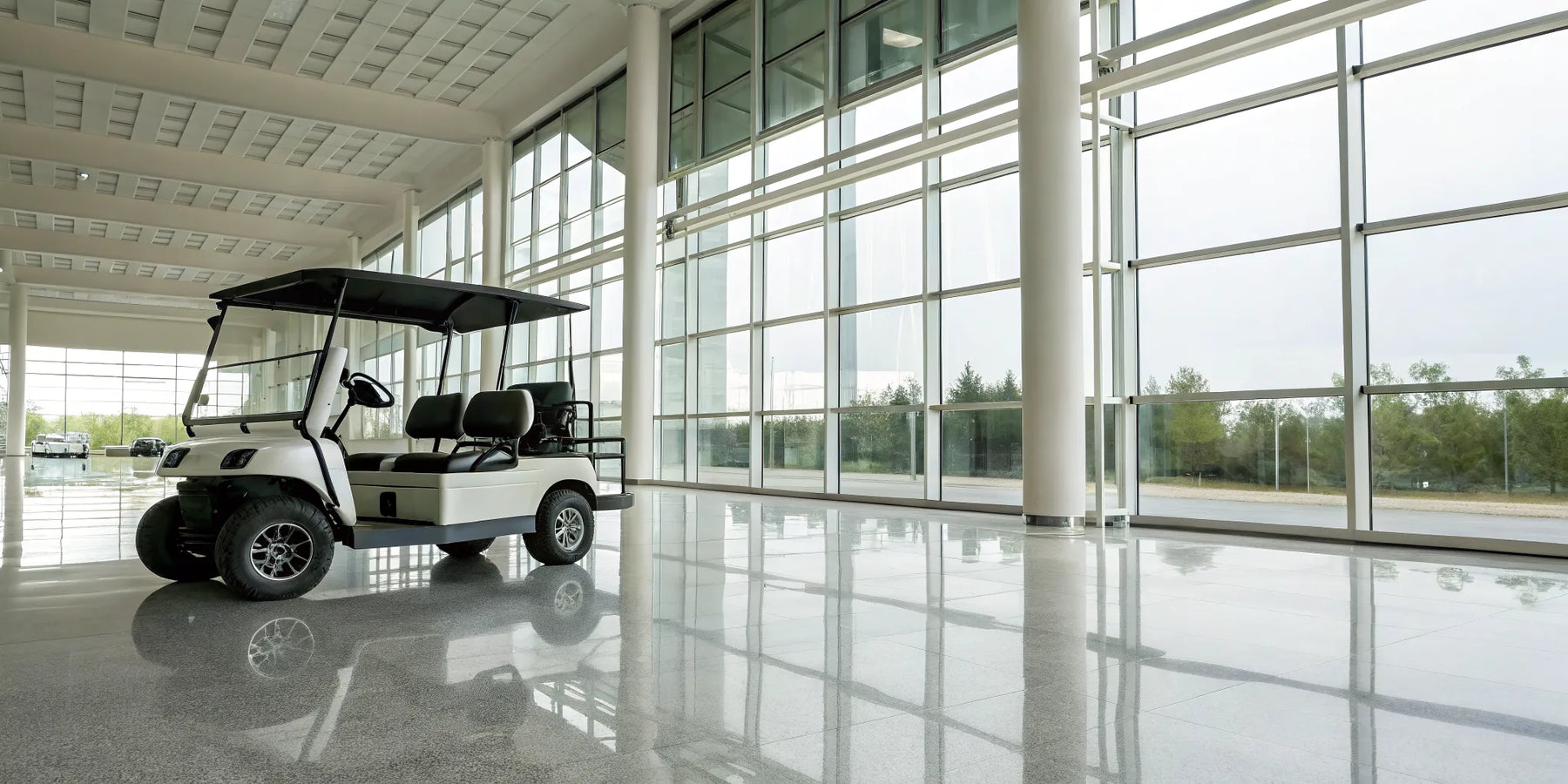 A modern six seater golf cart for sale in a dealership.