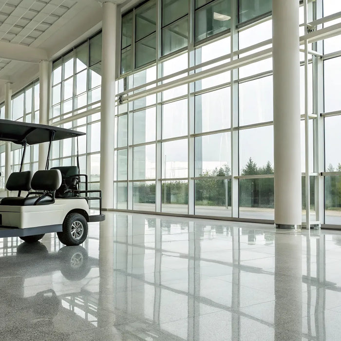 A modern six seater golf cart for sale in a dealership.