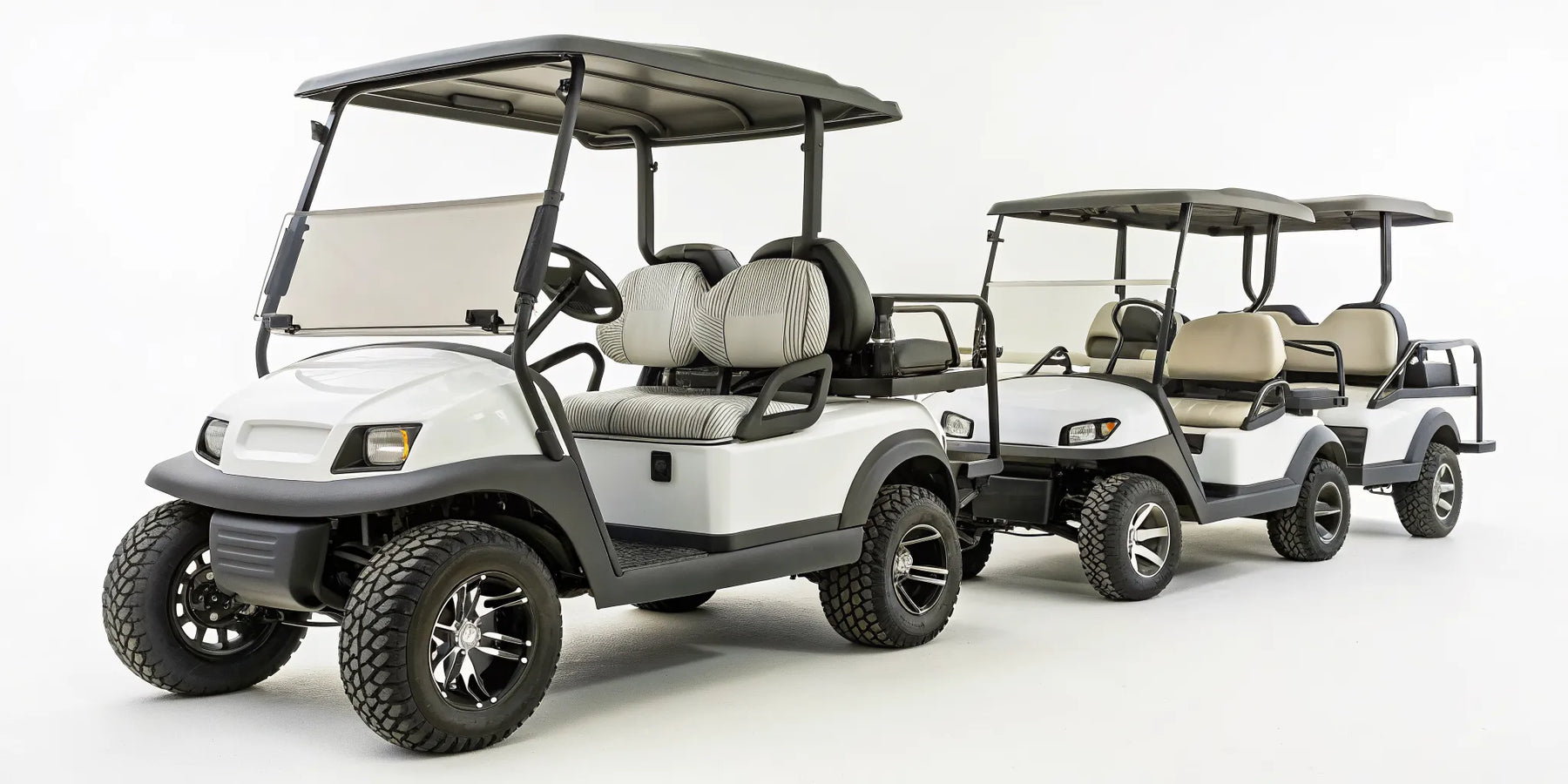 A white, lifted Club Car golf cart with multiple seats for personal and recreational use.