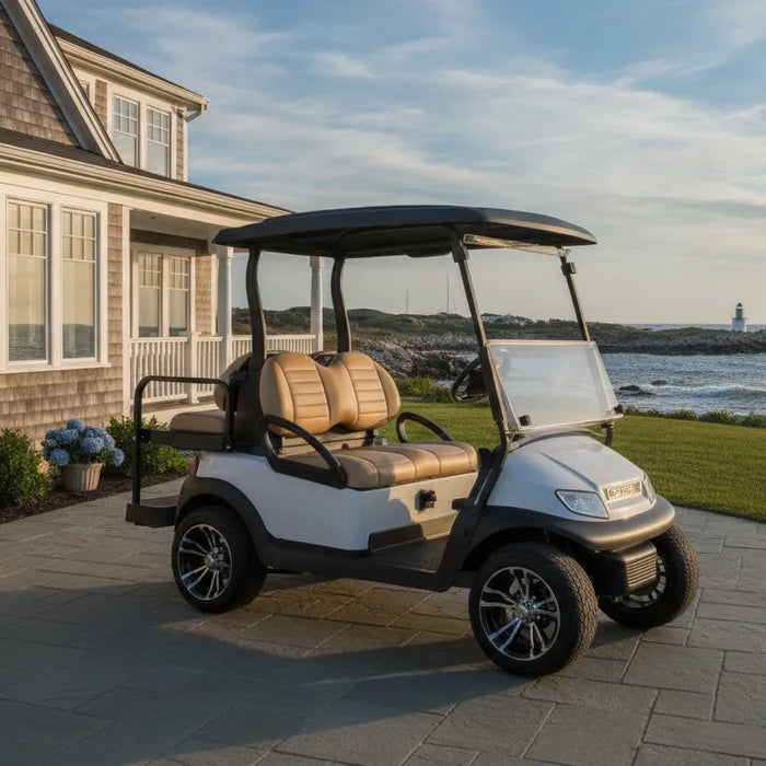 Club Car Onward golf cart near a New England coastal home