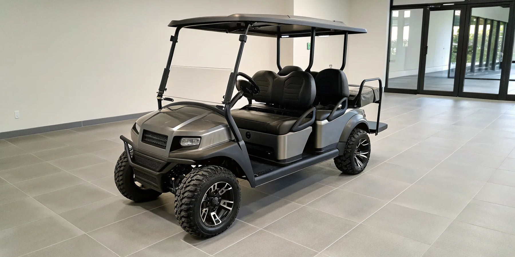 Lifted Club Car Onward with premium wheels and custom seats, features that affect the car price.
