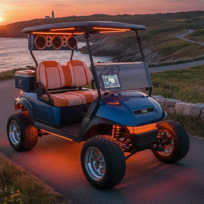 Customized golf cart with lifted suspension and LED lighting on a New England coastal road at sunset