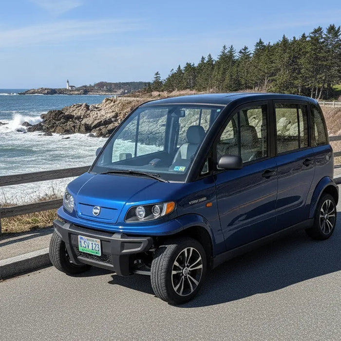 GEM electric low-speed vehicle on a New England coastal road