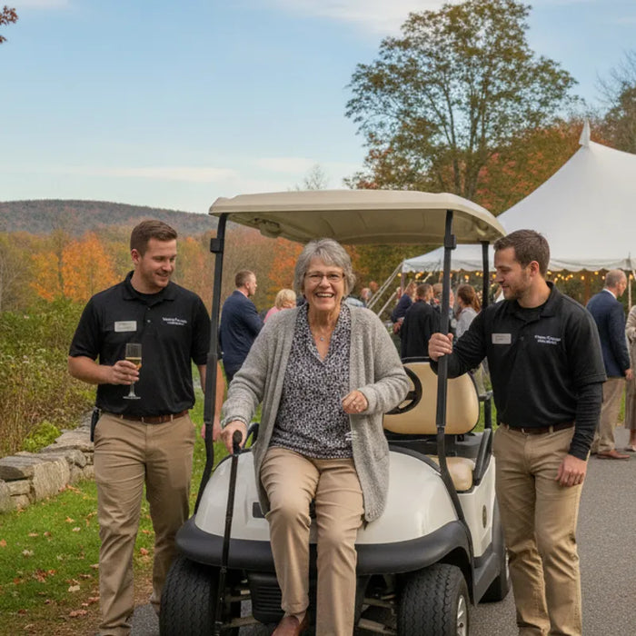Guest using a golf cart beside an outdoor event venue path