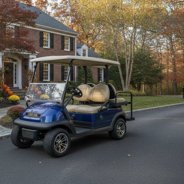 Blue Club Car Onward golf cart parked in front of a New England home with autumn foliage