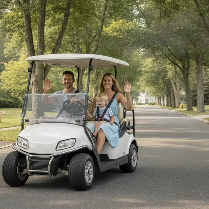 Family in a modern golf cart driving down a tree-lined New England neighborhood street