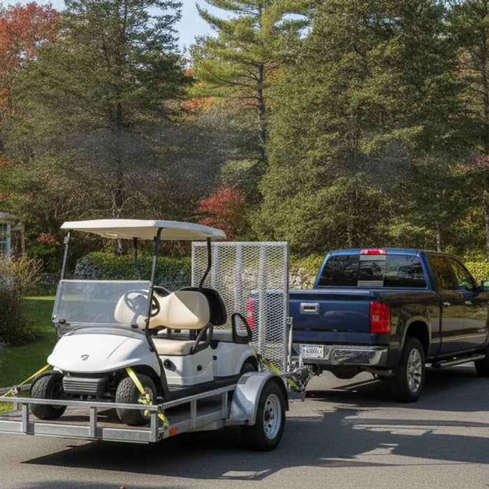 Golf cart positioned on an open trailer behind a pickup
