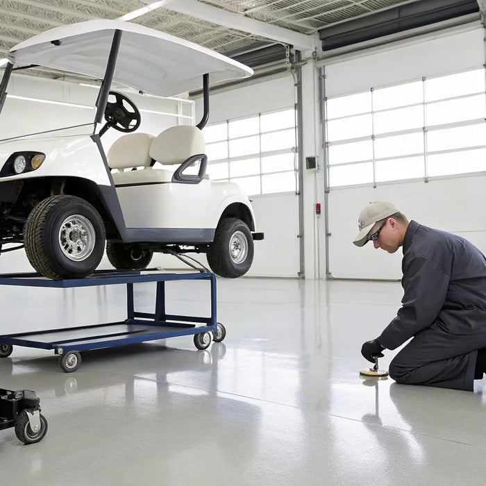 Golf cart on a jack in a garage during a lift kit installation.
