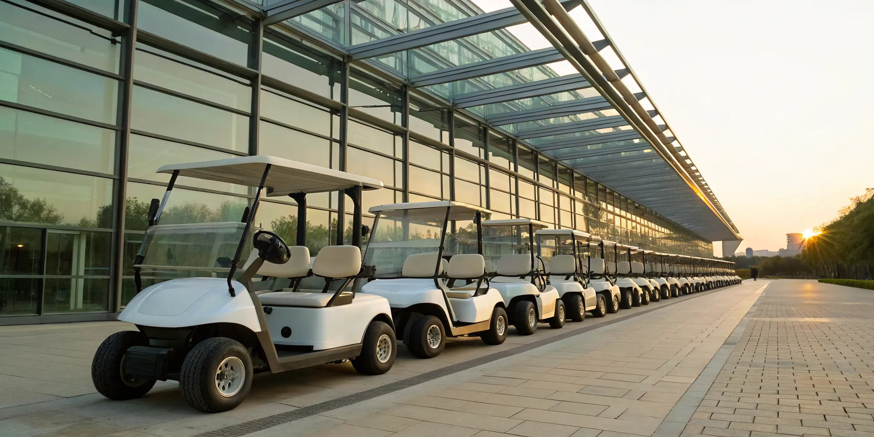 A row of white golf carts prepared for a long-term rental.