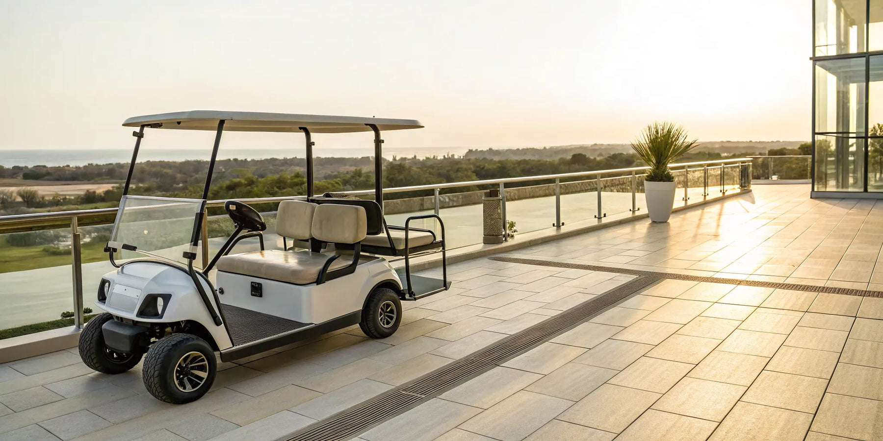 A luxury golf cart with a built-in table on a scenic patio at sunset.