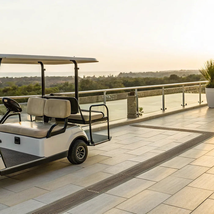 A luxury golf cart with a built-in table on a scenic patio at sunset.