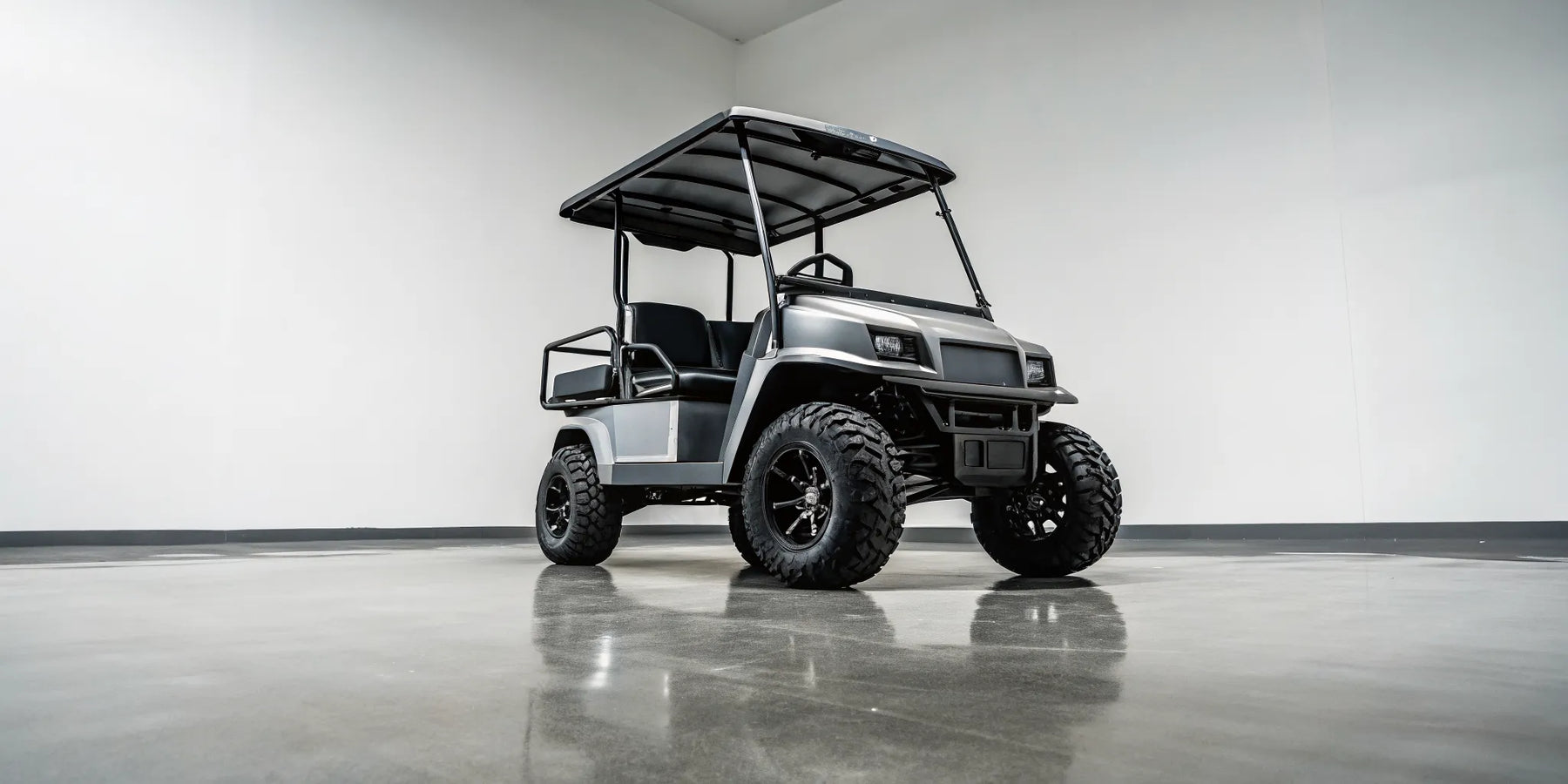 A custom monster golf cart with a lift kit and off-road tires in a showroom.