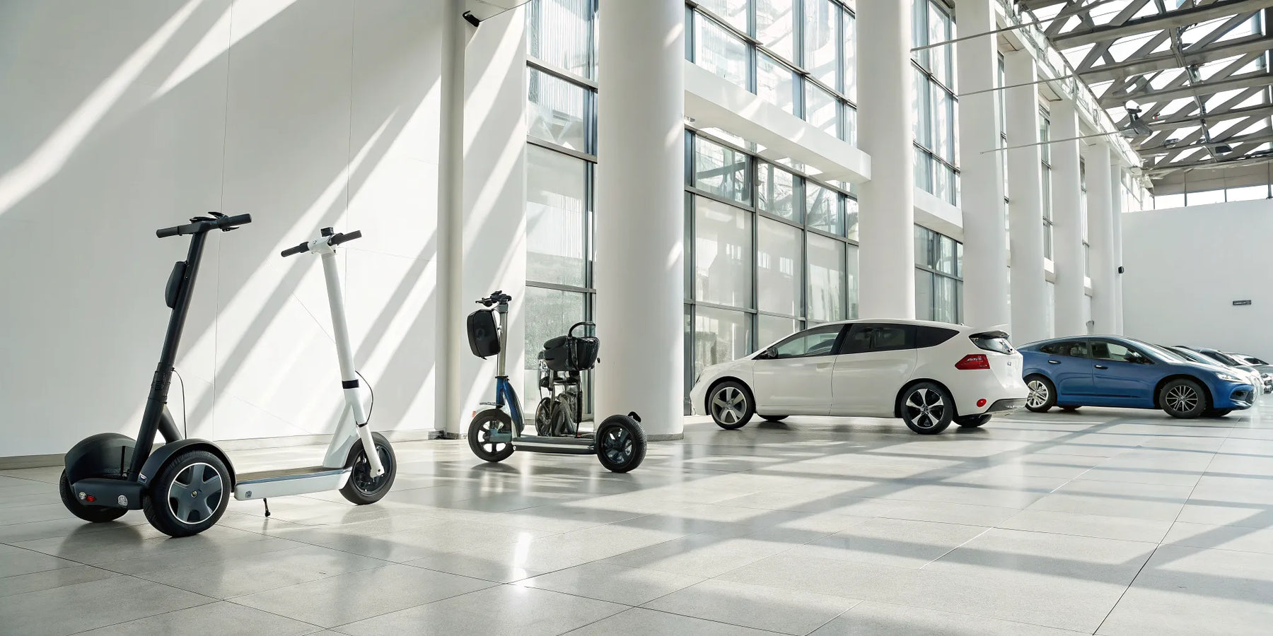 A variety of personal transportation vehicles, including golf carts and e-scooters, in a dealership showroom.