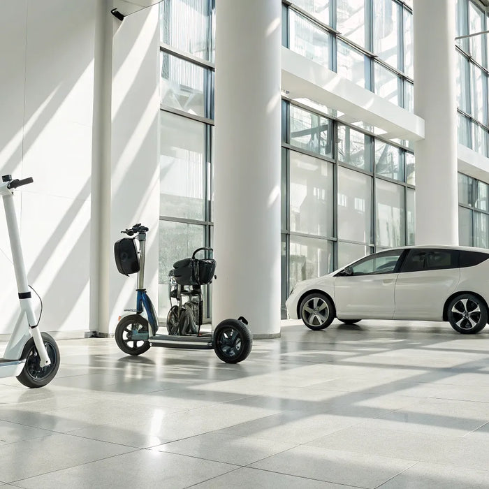 A variety of personal transportation vehicles, including golf carts and e-scooters, in a dealership showroom.
