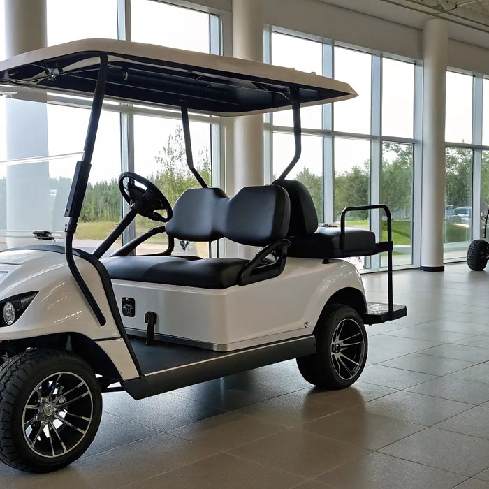 Modern white golf cart with black seats on display in a showroom.