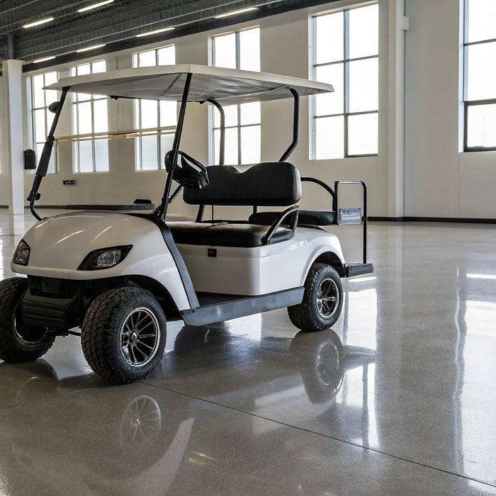 A clean used gas golf cart for sale at a dealership, ready for inspection.