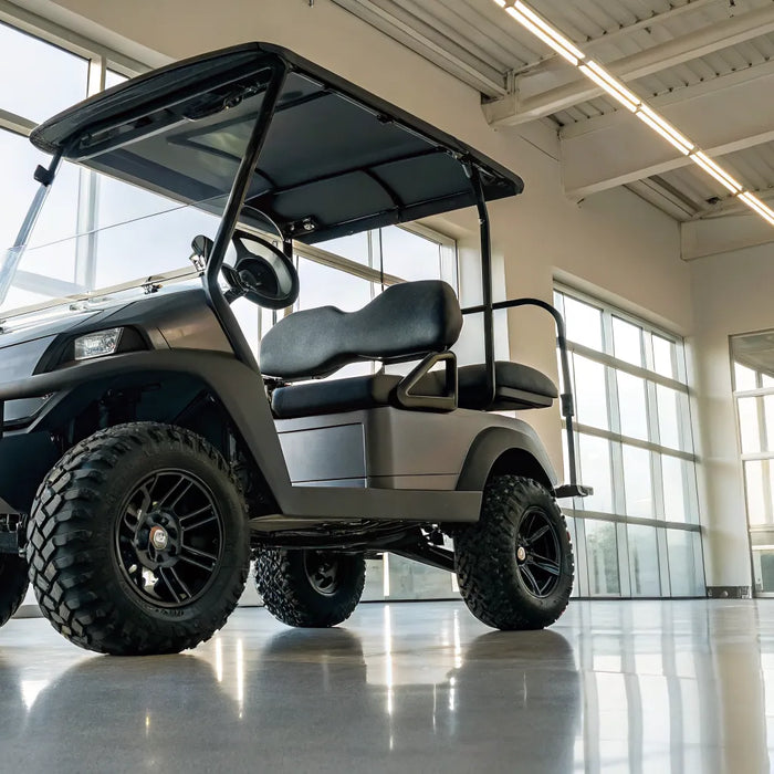 A modern lifted electric golf cart with large off-road tires and custom suspension.