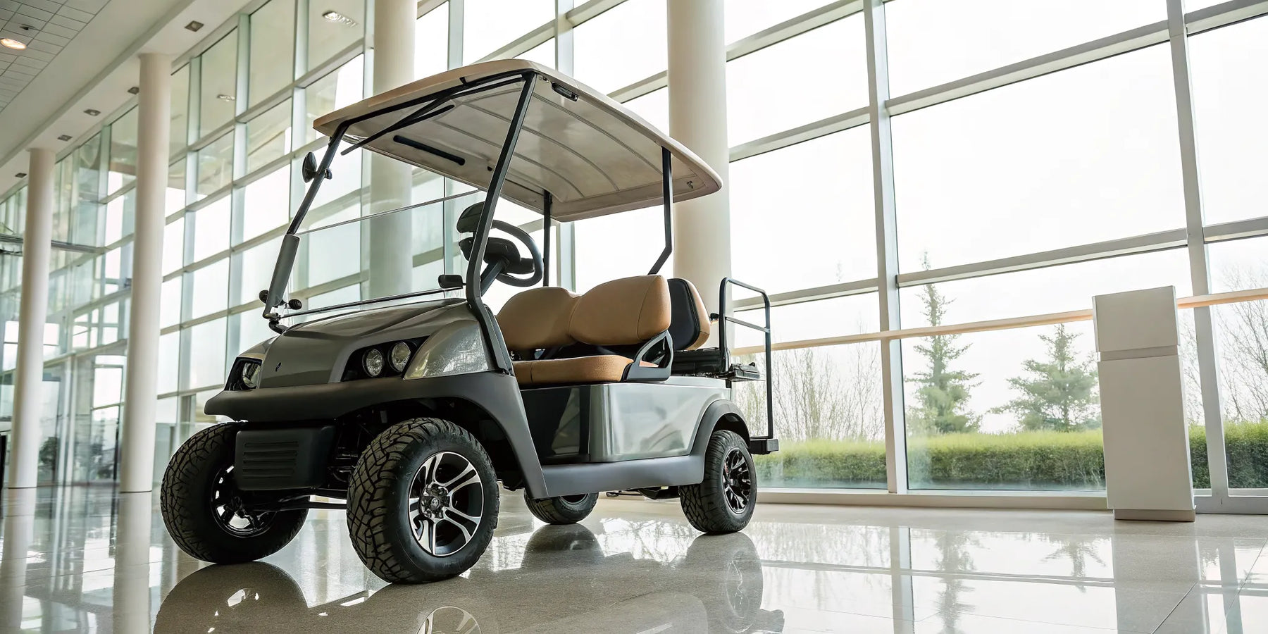 New Club Car golf cart for sale parked inside a bright dealership showroom.